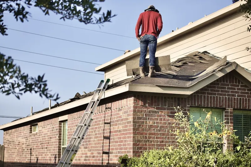 Professional roofer working on a residential roof in Shinnecock Hills